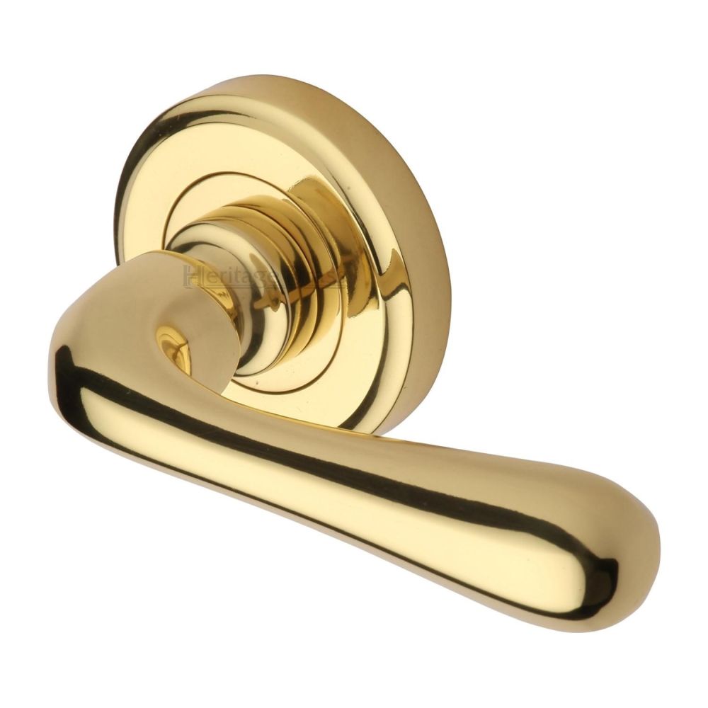 This is an image of a Heritage Brass - Door Handle Lever Latch on Round Rose Charlbury Design Polished Bra, v3020-pb that is available to order from T.H Wiggans Ironmongery in Kendal.