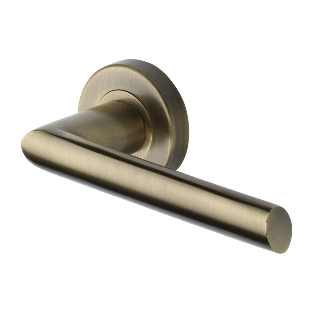 This is an image of a Heritage Brass - Door Handle Lever Latch on Round Rose Mercury Design Antique Brass, v3262-at that is available to order from T.H Wiggans Ironmongery in Kendal.