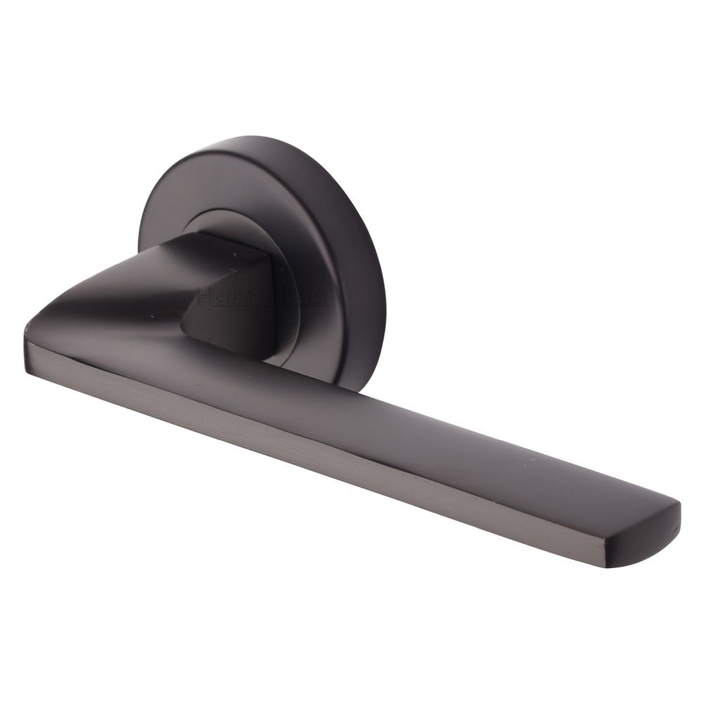 This is an image of a Heritage Brass - Door Handle Lever Latch on Round Rose Metro Angled Design Matt, v3790-mb that is available to order from T.H Wiggans Ironmongery in Kendal.