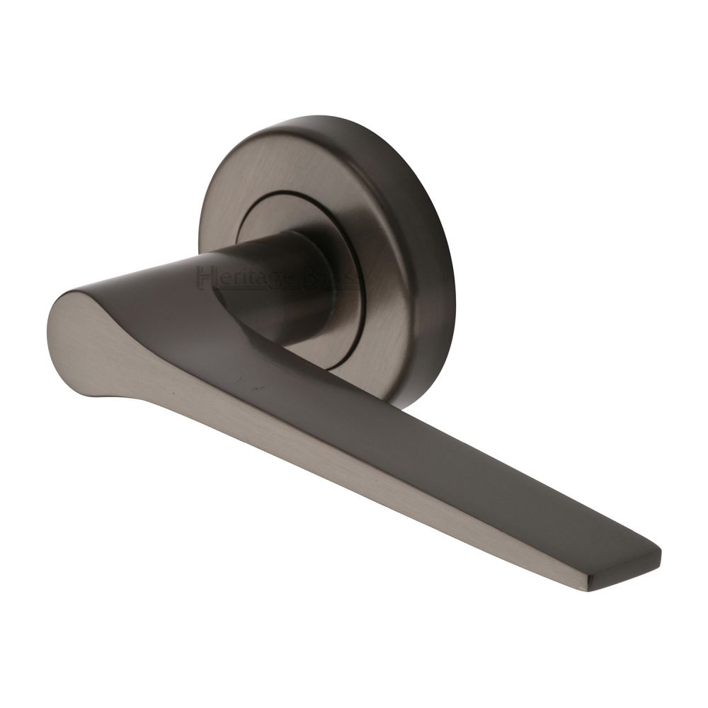 This is an image of a Heritage Brass - Door Handle Lever on Rose Gio Design Matt Bronze Finish, v4189-mb that is available to order from T.H Wiggans Ironmongery in Kendal.