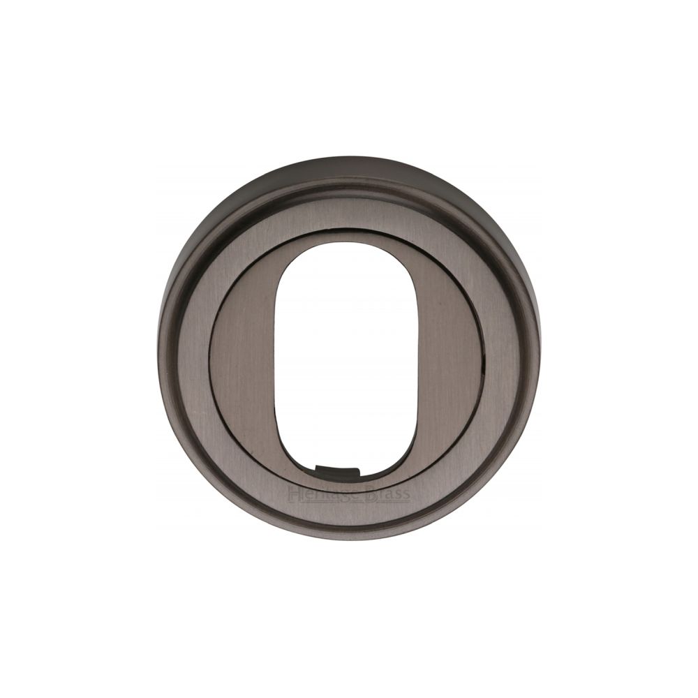 This is an image of a Heritage Brass - Oval Profile Cylinder Escutcheon Matt Bronze Finish, v5010-mb that is available to order from T.H Wiggans Ironmongery in Kendal.