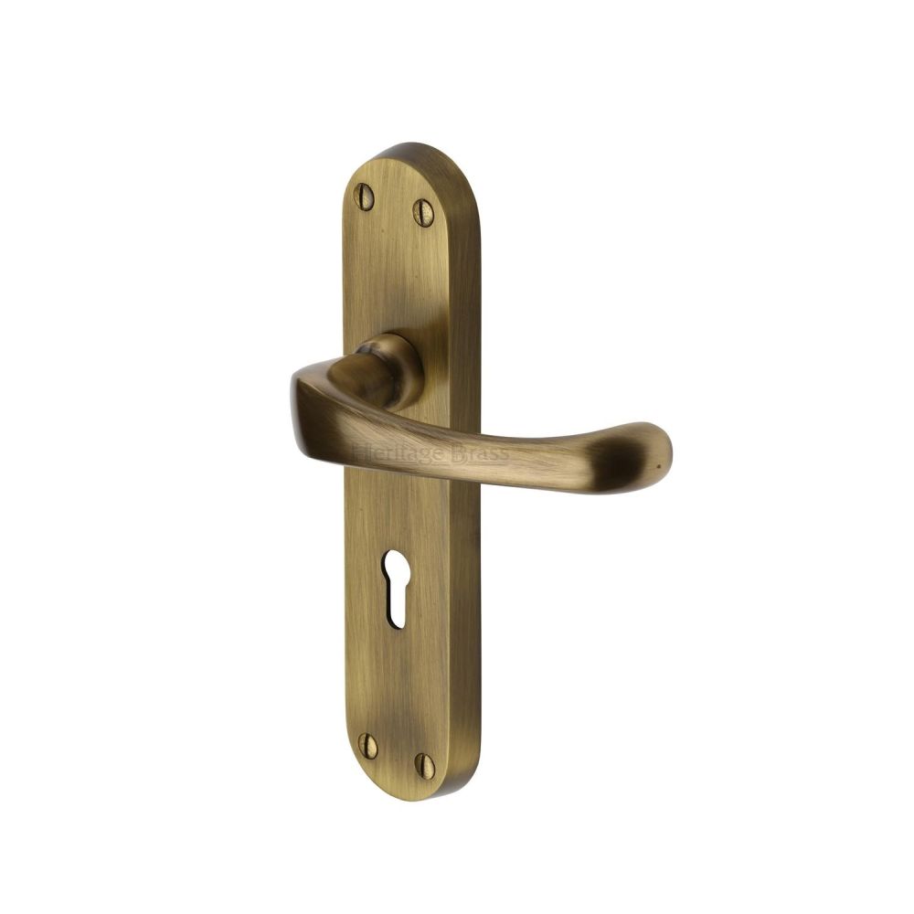 This is an image of a Heritage Brass - Door Handle Lever Lock Gloucester Design Antique Brass Finish, v6050-at that is available to order from T.H Wiggans Ironmongery in Kendal.