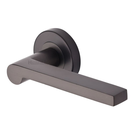 This is an image of a Heritage Brass - Door Handle Lever Latch on Round Rose Metro Mid Century Design, v6225-mb that is available to order from T.H Wiggans Ironmongery in Kendal.