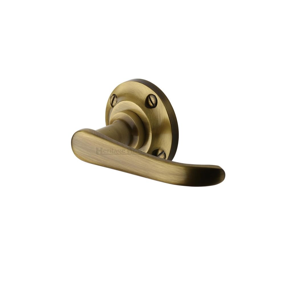This is an image of a Heritage Brass - Door Handle Lever Latch on Round Rose Windsor Design Antique Brass, v720-at that is available to order from T.H Wiggans Ironmongery in Kendal.