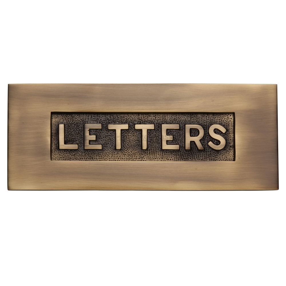 This is an image of a Heritage Brass - Embossed Letterplate 254 x 101mm - Antique Brass Finish, v845-at that is available to order from T.H Wiggans Ironmongery in Kendal.