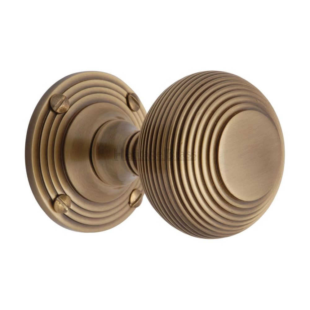This is an image of a Heritage Brass - Mortice Knob on Rose Reeded Design Antique Brass Finish, v971-at that is available to order from T.H Wiggans Ironmongery in Kendal.