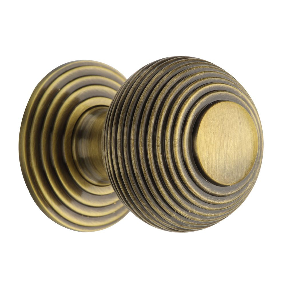 This is an image of a Heritage Brass - Cabinet Knob Reeded Design 38mm Antique Brass Finish, v973-38-at that is available to order from T.H Wiggans Ironmongery in Kendal.