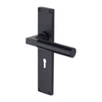 This is an image of a Heritage Brass - Bauhaus Lever Lock Door Handle on 200mm Plate Matt Black finish, vt6300-bkmt that is available to order from T.H Wiggans Ironmongery in Kendal.