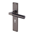 This is an image of a Heritage Brass - Bauhaus Lever Lock Door Handle on 200mm Plate Matt Bronze finish, vt6300-mb that is available to order from T.H Wiggans Ironmongery in Kendal.