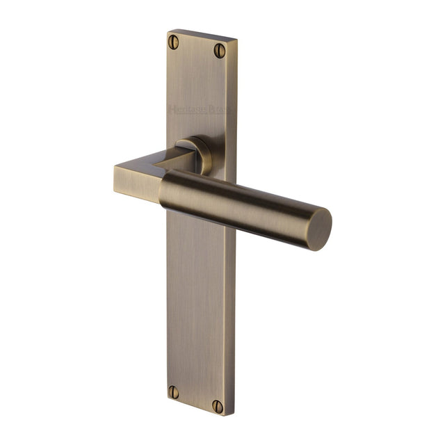 This is an image of a Heritage Brass - Bauhaus Lever Latch Door Handle on 200mm Plate Antique Brass finish, vt6310-at that is available to order from T.H Wiggans Ironmongery in Kendal.