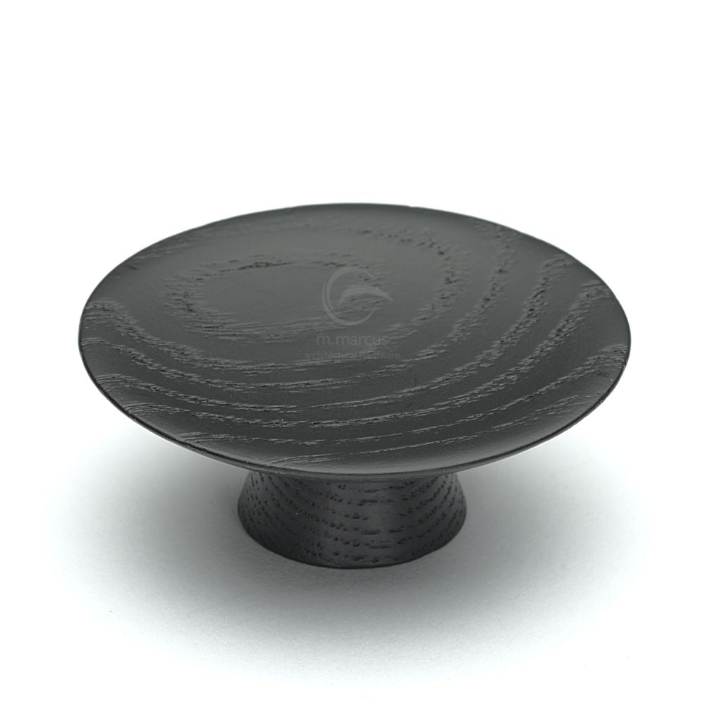 This is an image of a M.Marcus - Wooden Cabinet Knob Convex Design 65mm Black Ash Finish, w4343-65-ash that is available to order from T.H Wiggans Ironmongery in Kendal.
