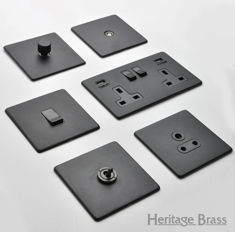 Image showing a range of electrical switches and sockets in Matt Black by Heritage Brass, Available to order from T.H Wiggans Ironmongery in Kendal