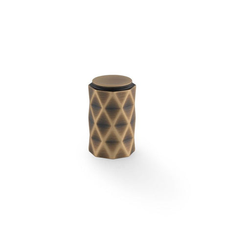 This is an image showing Alexander & Wilks Diamond Cut Cylinder Cabinet Knob - 30mm - Antique Brass - AW847-30-AB available to order from T.H. Wiggans Ironmongery in Kendal, quick delivery and discounted prices.