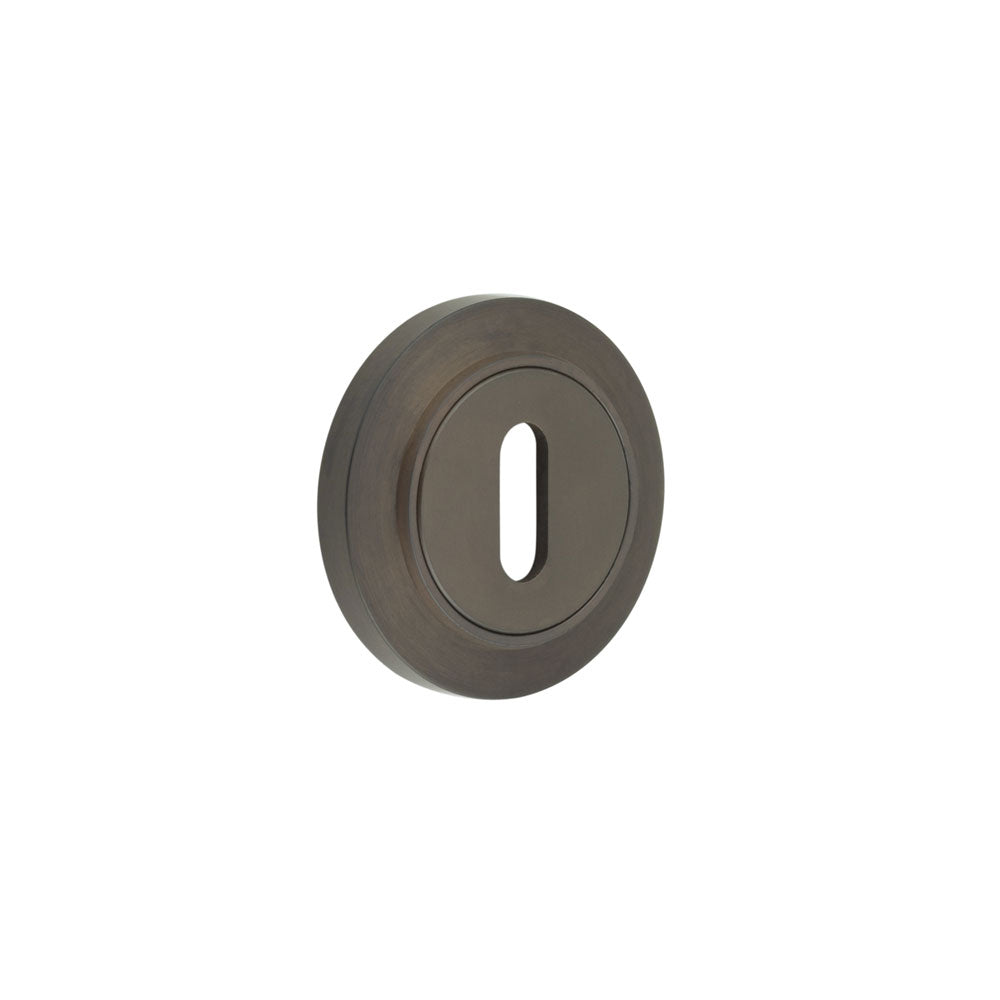 This is an image showing the Frelan - Burlington Standard Keyway Escutcheons Chamfered Rose Dark Bronze available to order from T.H. Wiggans Ironmongery in Kendal