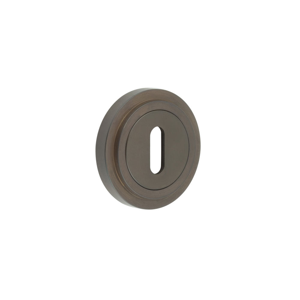 This is an image showing the Frelan - Burlington Standard Keyway Escutcheons Stepped Rose Dark Bronze available to order from T.H. Wiggans Ironmongery in Kendal