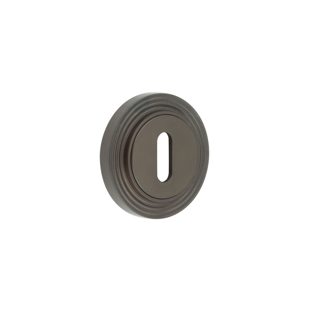 This is an image showing the Frelan - Burlington Standard Keyway Escutcheons Reeded Rose Dark Bronze available to order from T.H. Wiggans Ironmongery in Kendal
