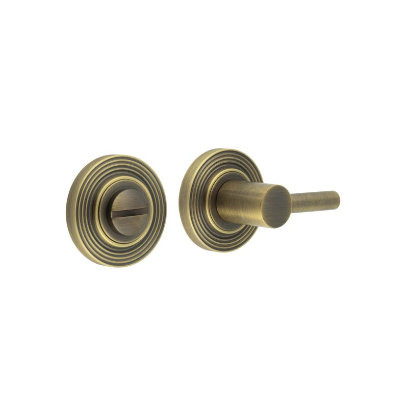 This is an image showing the Frelan - Burlington Easy Turn & Release Reeded Rose Antique Brass available to order from T.H. Wiggans Ironmongery in Kendal