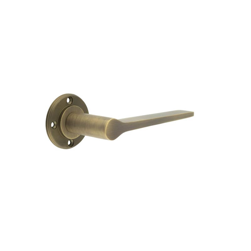 This is an image showing the Burlington - Knightsbridge lever on rose - Antique Brass available to order from T.H. Wiggans Ironmongery in Kendal