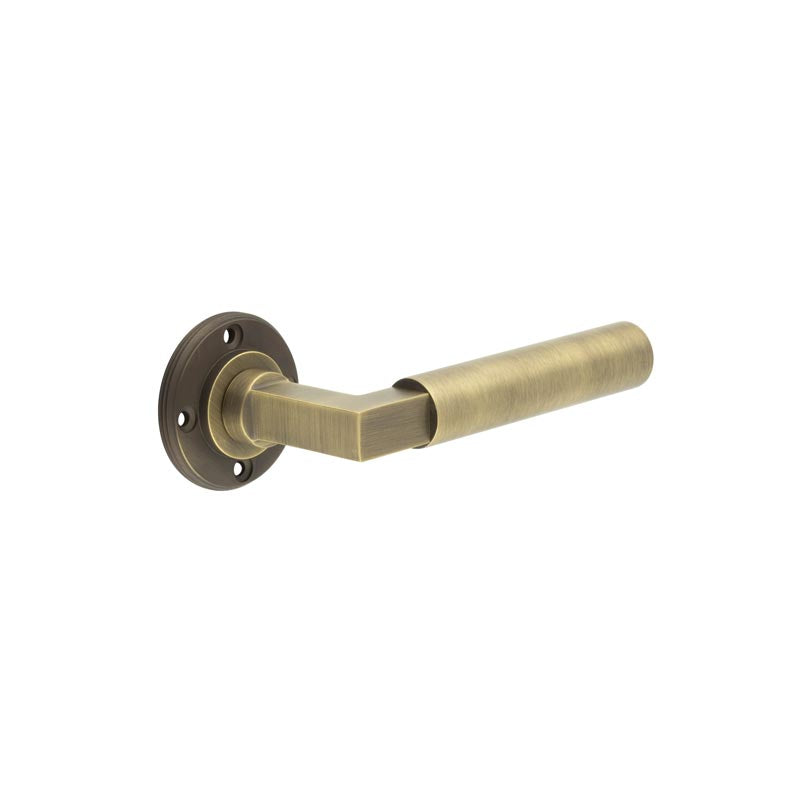 This is an image showing the Burlington - Westminster lever on rose - Antique Brass available to order from T.H. Wiggans Ironmongery in Kendal
