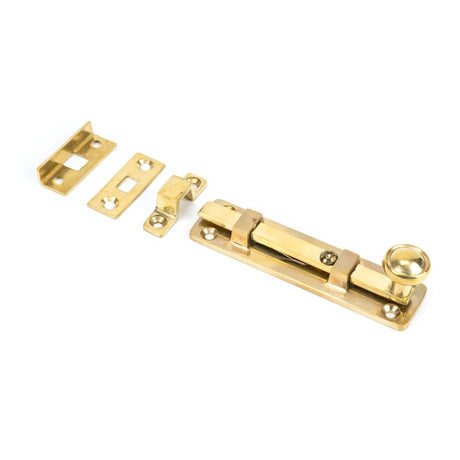 This is an image showing From The Anvil - Polished Brass 4" Universal Bolt available from T.H Wiggans Architectural Ironmongery in Kendal, quick delivery and discounted prices