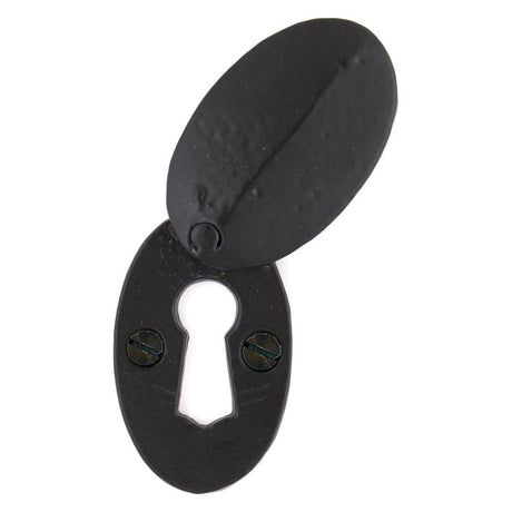 This is an image of From The Anvil - Black Oval Escutcheon & Cover available to order from T.H Wiggans Architectural Ironmongery in Kendal, quick delivery and discounted prices.