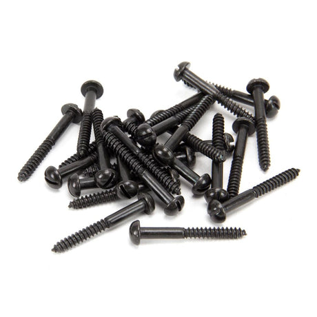 This is an image showing From The Anvil - Black 10 x 1 1/2" Round Head Screws (25) available from T.H Wiggans Architectural Ironmongery in Kendal, quick delivery and discounted prices