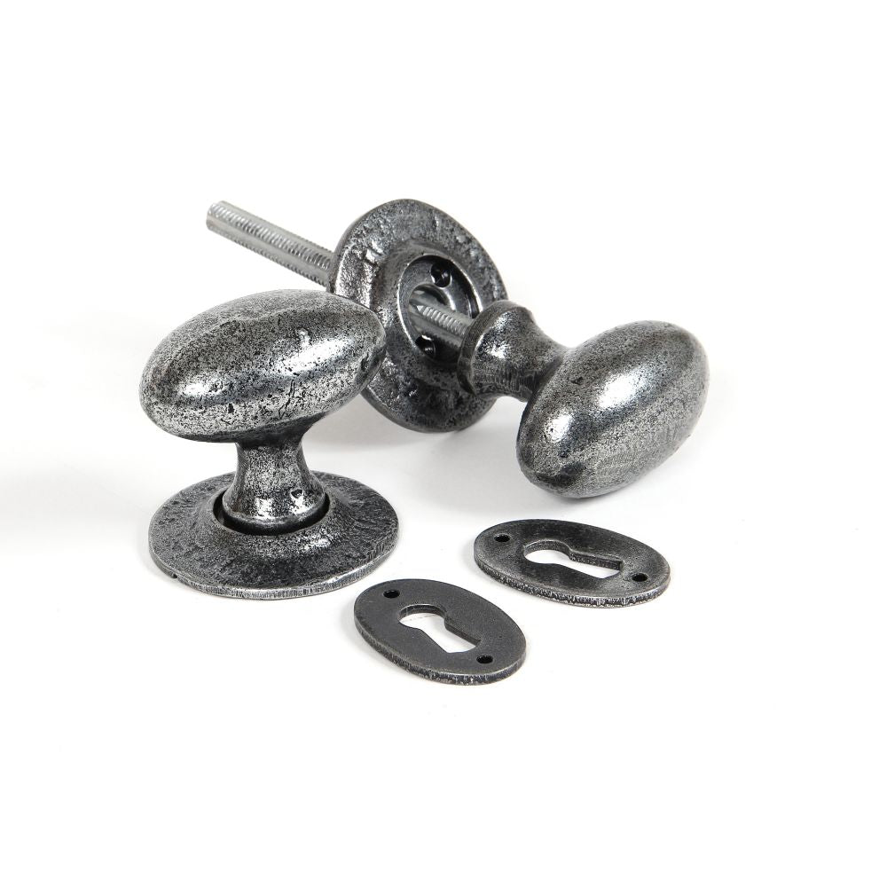 This is an image of From The Anvil - Pewter Oval Mortice/Rim Knob Set available to order from T.H Wiggans Architectural Ironmongery in Kendal, quick delivery and discounted prices.