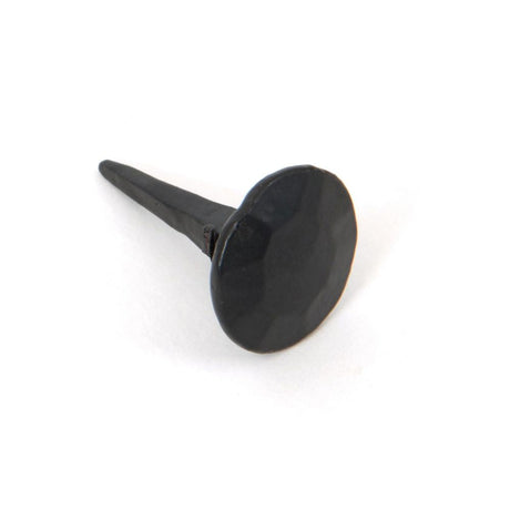 This is an image showing From The Anvil - Black 1" Handmade Nail (20mm HD DIA) available from T.H Wiggans Architectural Ironmongery in Kendal, quick delivery and discounted prices