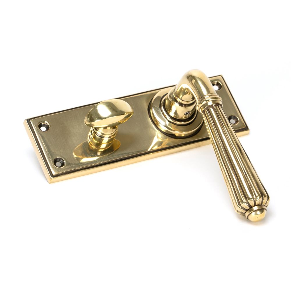 This is an image showing From The Anvil - Aged Brass Hinton Lever Bathroom Set available from trade door handles, quick delivery and discounted prices