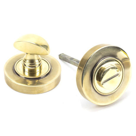 This is an image of From The Anvil - Aged Brass Round Thumbturn Set (Plain) available to order from T.H Wiggans Architectural Ironmongery in Kendal, quick delivery and discounted prices.