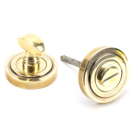 This is an image of From The Anvil - Aged Brass Round Thumbturn Set (Art Deco) available to order from T.H Wiggans Architectural Ironmongery in Kendal, quick delivery and discounted prices.