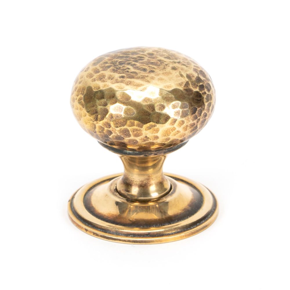 This is an image showing From The Anvil - Aged Brass Hammered Mushroom Cabinet Knob 38mm available from T.H Wiggans Architectural Ironmongery in Kendal, quick delivery and discounted prices