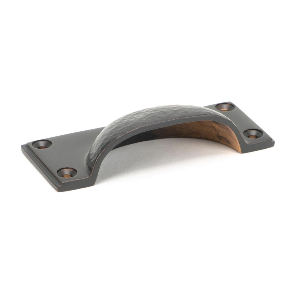 This is an image showing From The Anvil - Aged Bronze Hammered Art Deco Drawer Pull available from trade door handles, quick delivery and discounted prices
