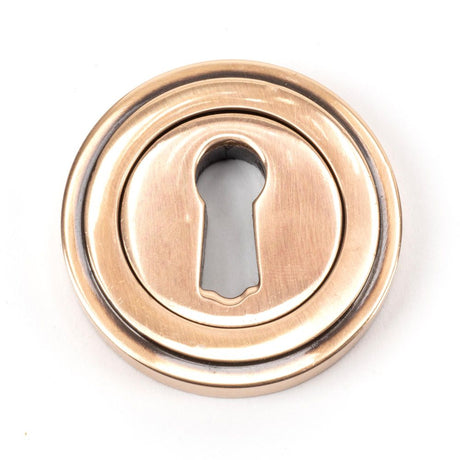 This is an image of From The Anvil - Polished Bronze Round Escutcheon (Art Deco) available to order from T.H Wiggans Architectural Ironmongery in Kendal, quick delivery and discounted prices.