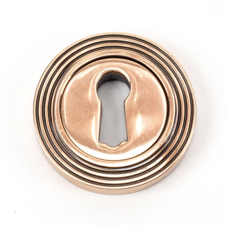 This is an image of From The Anvil - Polished Bronze Round Escutcheon (Beehive) available to order from T.H Wiggans Architectural Ironmongery in Kendal, quick delivery and discounted prices.