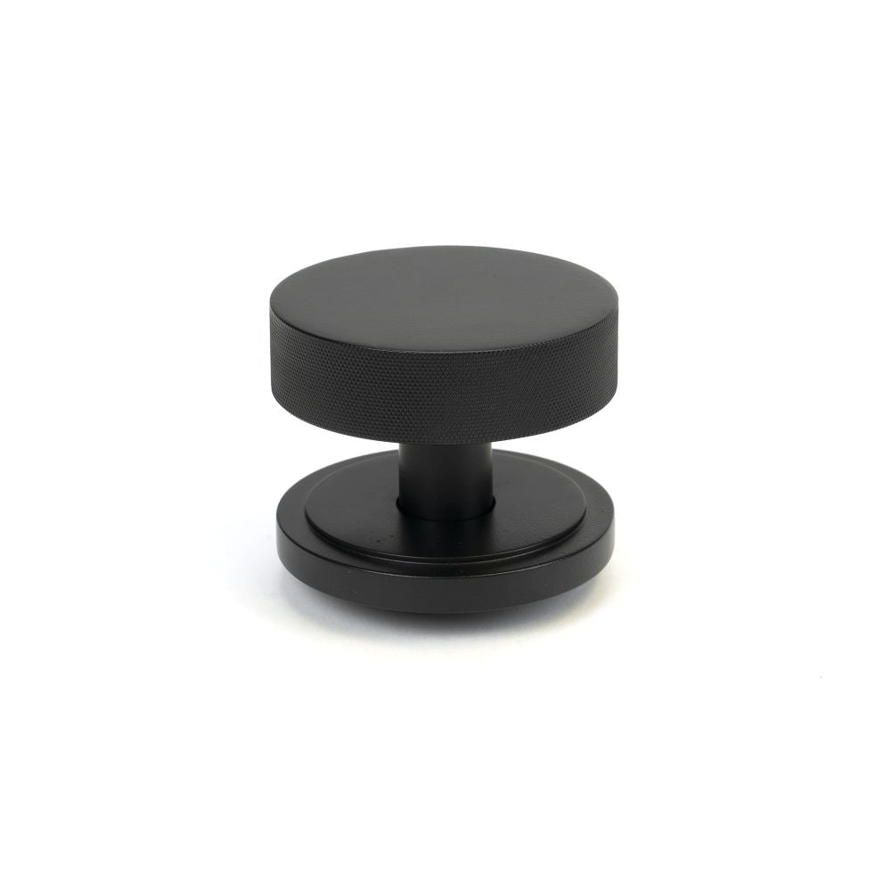 This is an image of From The Anvil - Matt Black Brompton Centre Door Knob (Art Deco) available to order from T.H Wiggans Architectural Ironmongery in Kendal, quick delivery and discounted prices.