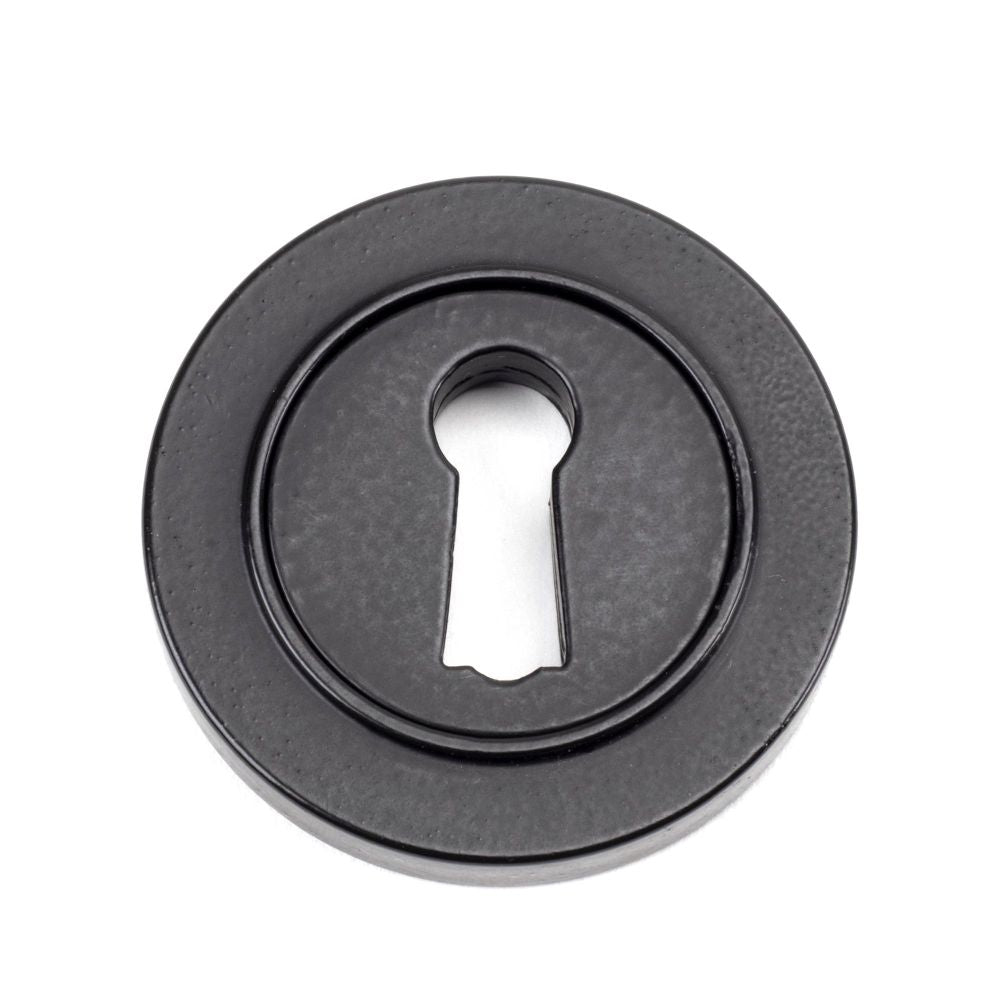 This is an image of From The Anvil - Matt Black Round Escutcheon (Plain) available to order from T.H Wiggans Architectural Ironmongery in Kendal, quick delivery and discounted prices.