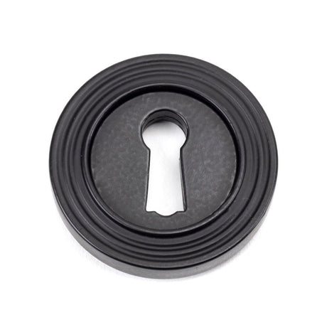 This is an image of From The Anvil - Matt Black Round Escutcheon (Beehive) available to order from T.H Wiggans Architectural Ironmongery in Kendal, quick delivery and discounted prices.