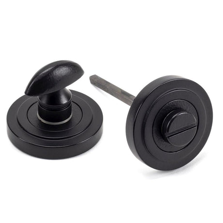 This is an image of From The Anvil - Matt Black Round Thumbturn Set (Art Deco) available to order from T.H Wiggans Architectural Ironmongery in Kendal, quick delivery and discounted prices.