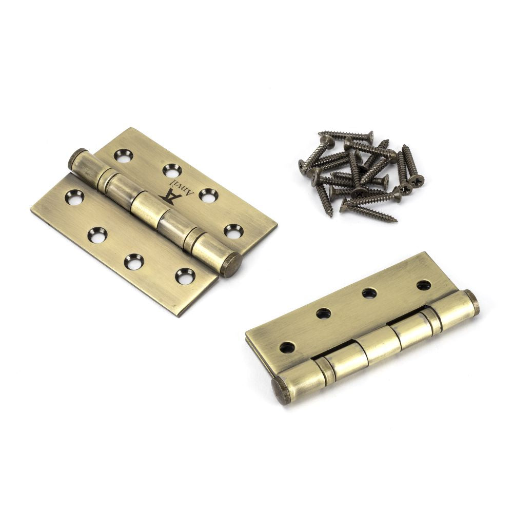 This is an image showing From The Anvil - Aged Brass 4" Ball Bearing Butt Hinge (pair) ss available from T.H Wiggans Architectural Ironmongery, quick delivery and discounted prices