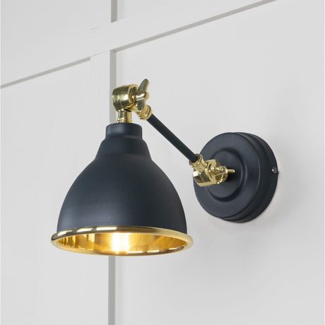 This is an image showing From The Anvil - Smooth Brass Brindley Wall Light in Soot available from T.H Wiggans Architectural Ironmongery in Kendal, quick delivery and discounted prices