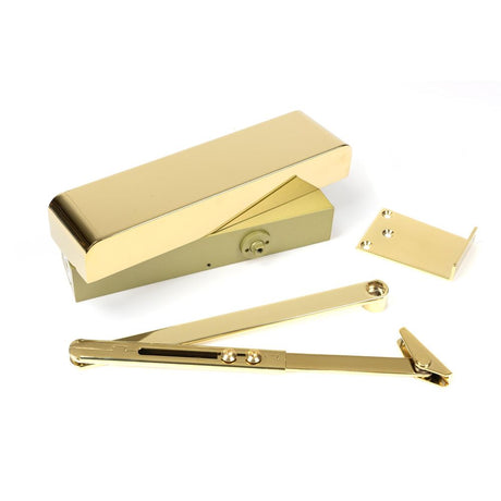 This is an image of From The Anvil - Polished Brass Size 2-5 Door Closer & Cover available to order from T.H Wiggans Architectural Ironmongery in Kendal, quick delivery and discounted prices.