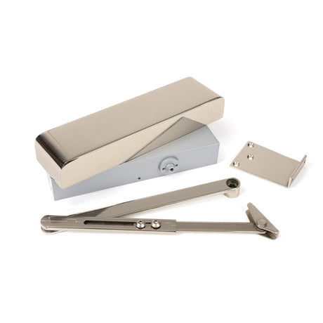 This is an image of From The Anvil - Polished Nickel Size 2-5 Door Closer & Cover available to order from T.H Wiggans Architectural Ironmongery in Kendal, quick delivery and discounted prices.