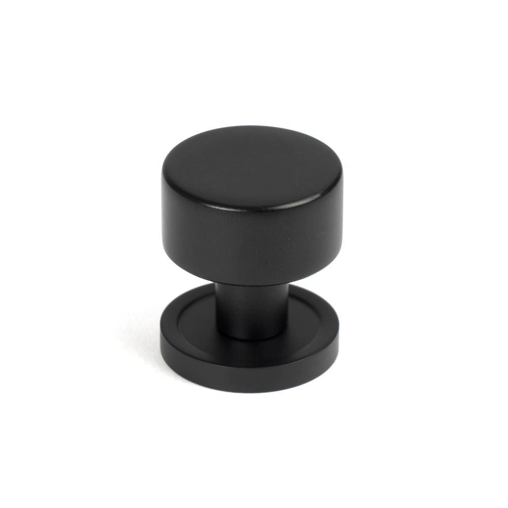 This is an image showing From The Anvil - Matt Black Kelso Cabinet Knob - 25mm (Plain) available from T.H Wiggans Architectural Ironmongery in Kendal, quick delivery and discounted prices
