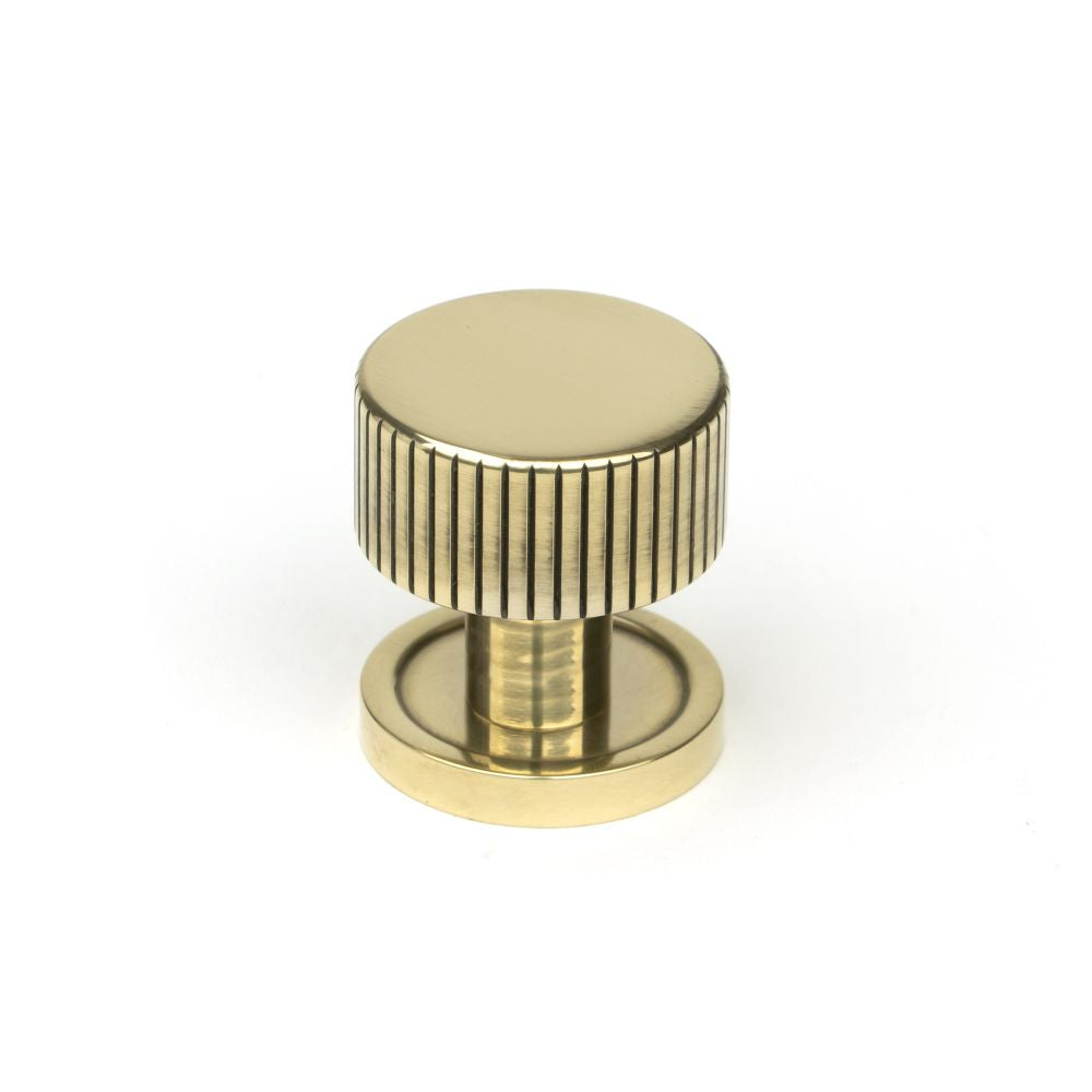 This is an image showing From The Anvil - Aged Brass Judd Cabinet Knob - 25mm (Plain) available from T.H Wiggans Architectural Ironmongery in Kendal, quick delivery and discounted prices