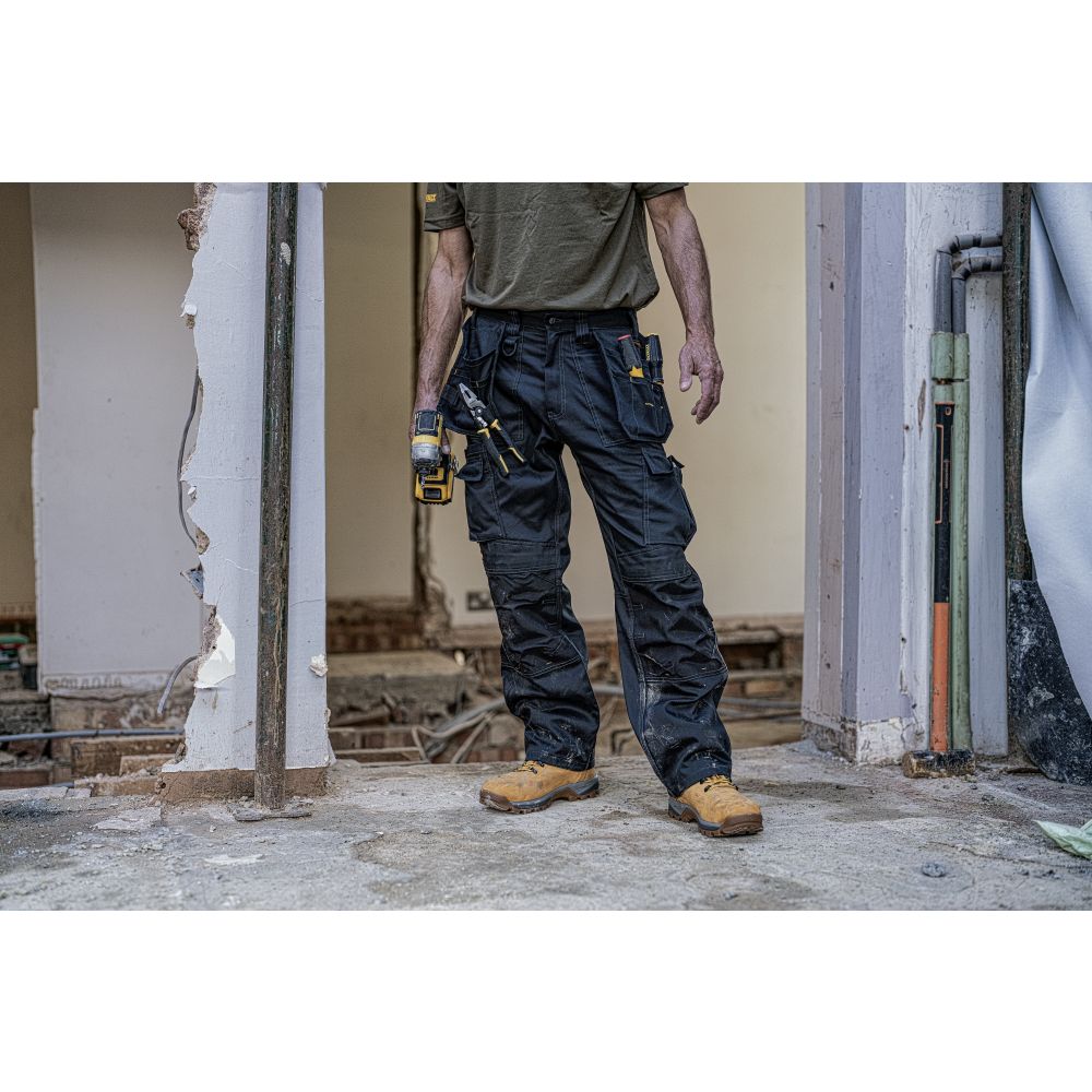 This is an image of DeWalt - Black Knee Pad Holster Trouser Pro Tradesman Trouser L31W32 available to order from T.H Wiggans Architectural Ironmongery in Kendal, quick delivery and discounted prices.