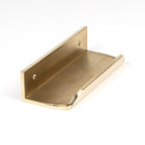 This is an image showing From The Anvil - Polished Brass 100mm Moore Edge Pull available from trade door handles, quick delivery and discounted prices