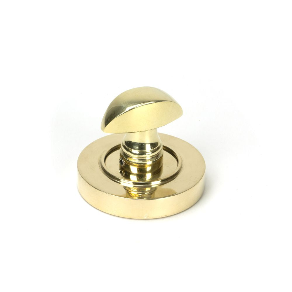 This is an image showing From The Anvil - Polished Brass Round Thumbturn Set (Plain) available from trade door handles, quick delivery and discounted prices