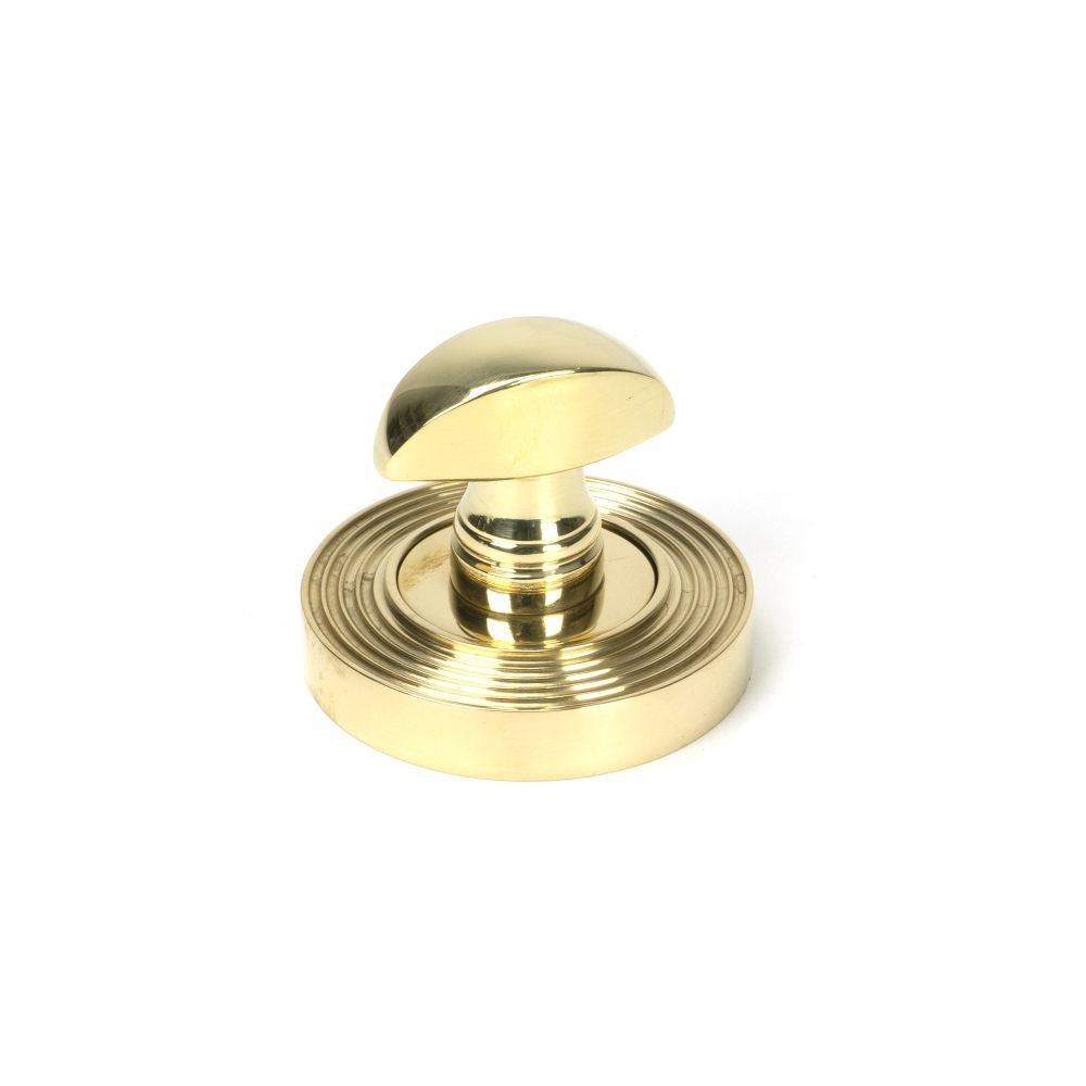 This is an image showing From The Anvil - Polished Brass Round Thumbturn Set (Beehive) available from trade door handles, quick delivery and discounted prices