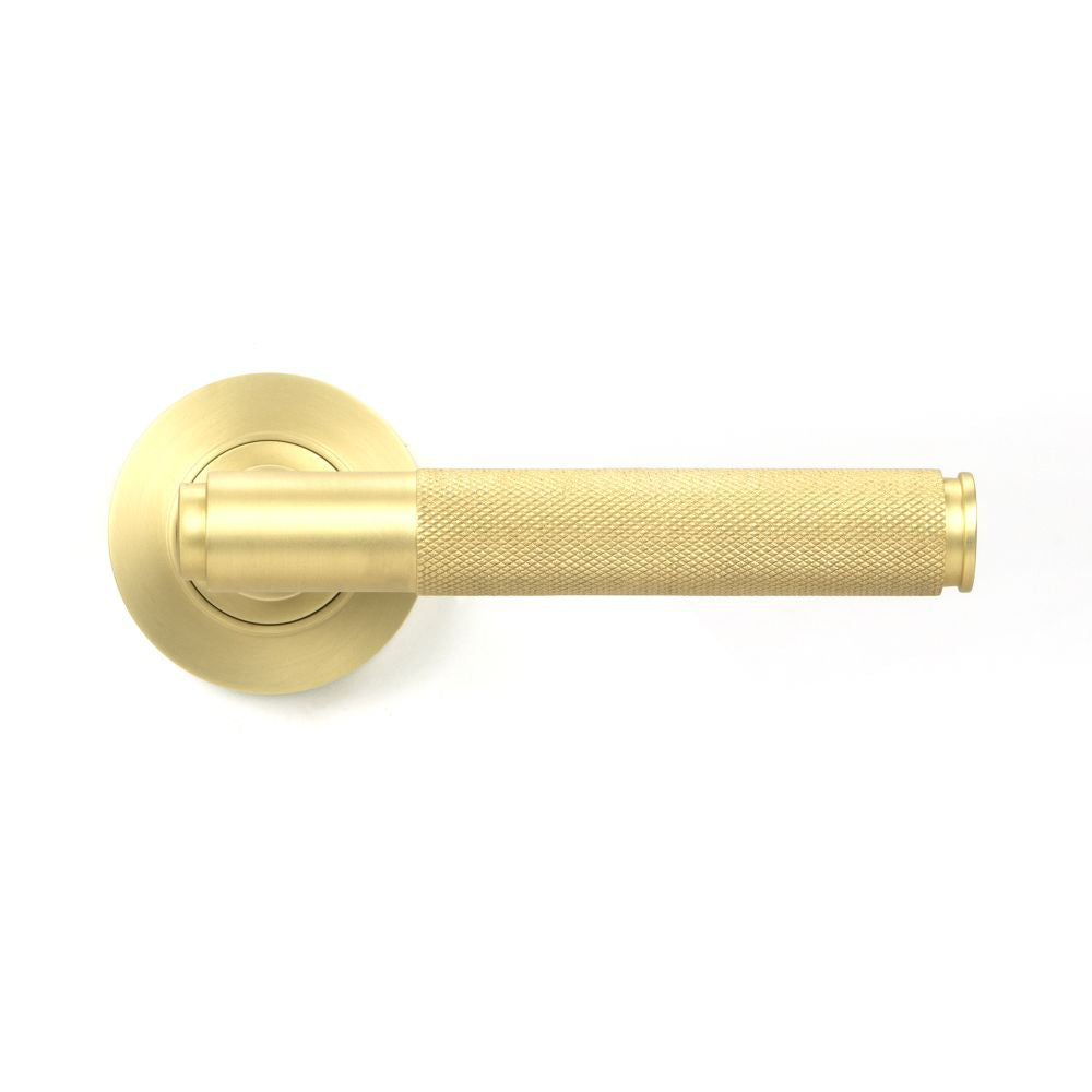 This is an image showing From The Anvil - Satin Brass Brompton Lever on Rose Set (Plain) available from trade door handles, quick delivery and discounted prices